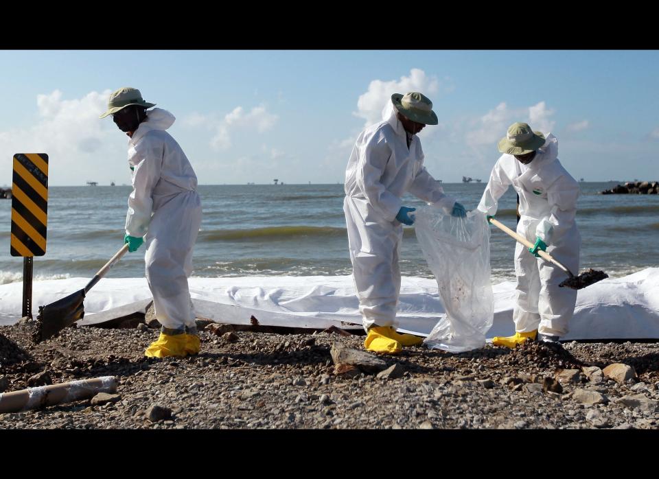 PORT FOURCHON, LA - JULY 03:  Workers clear off some of the oil washing on to Fourchon Beach from the Deepwater Horizon oil spill in the Gulf of Mexico on July 3, 2010 in Port Fourchon, Louisiana. Millions of gallons of oil have spilled into the Gulf since the April 20 explosion on the drilling platform.   (Photo by Joe Raedle/Getty Images)