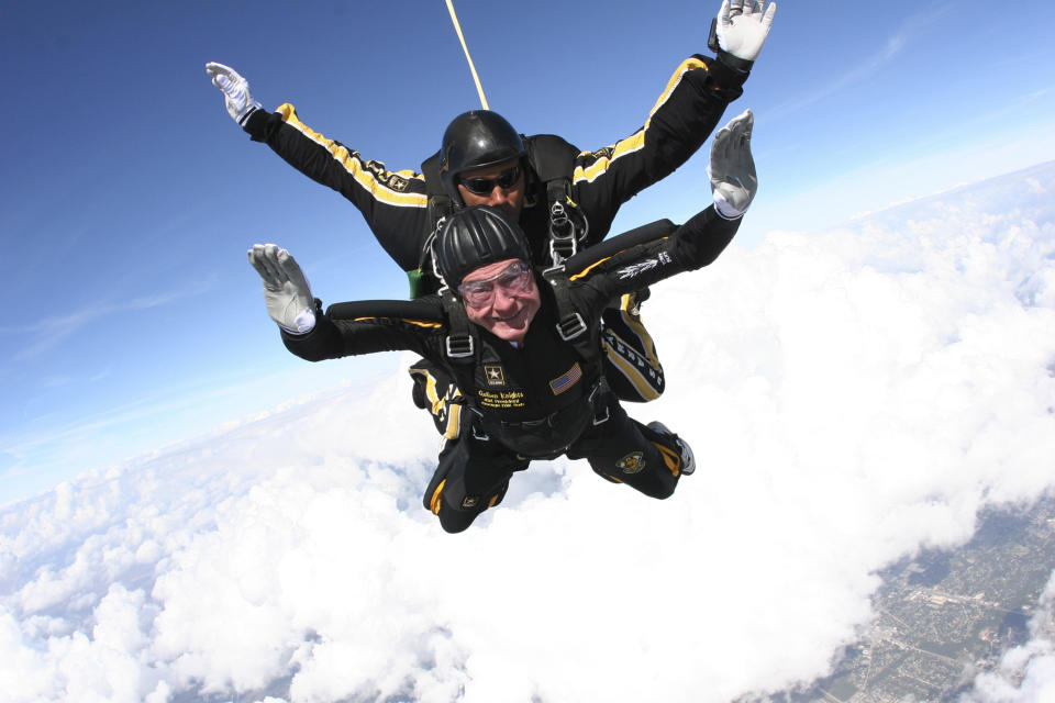 FILE - In this Nov. 10, 2007, file photo provided by the U.S. Army Golden Knights, former President George H.W. Bush free falls with Golden Knights parachute team member Sgt. 1st Class Mike Elliott, as he makes a dramatic entrance to his presidential museum during a rededication ceremony in College Station, Texas. Bush died at the age of 94 on Friday, Nov. 30, 2018, about eight months after the death of his wife, Barbara Bush. (Sgt. 1st Class Kevin McDaniel/U.S. Army via AP, File)