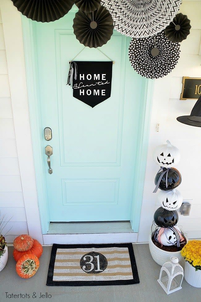 <p>A black-and-white theme elevates the entire atmosphere of this charming front porch. It'll get all your neighbors in the Halloween spirit—without scaring them.</p><p><strong>Get the tutorial at <a href="https://tatertotsandjello.com/witching-hour-halloween-porch-ideas/" rel="nofollow noopener" target="_blank" data-ylk="slk:Tatertots + Jello;elm:context_link;itc:0;sec:content-canvas" class="link ">Tatertots + Jello</a>.</strong> </p>