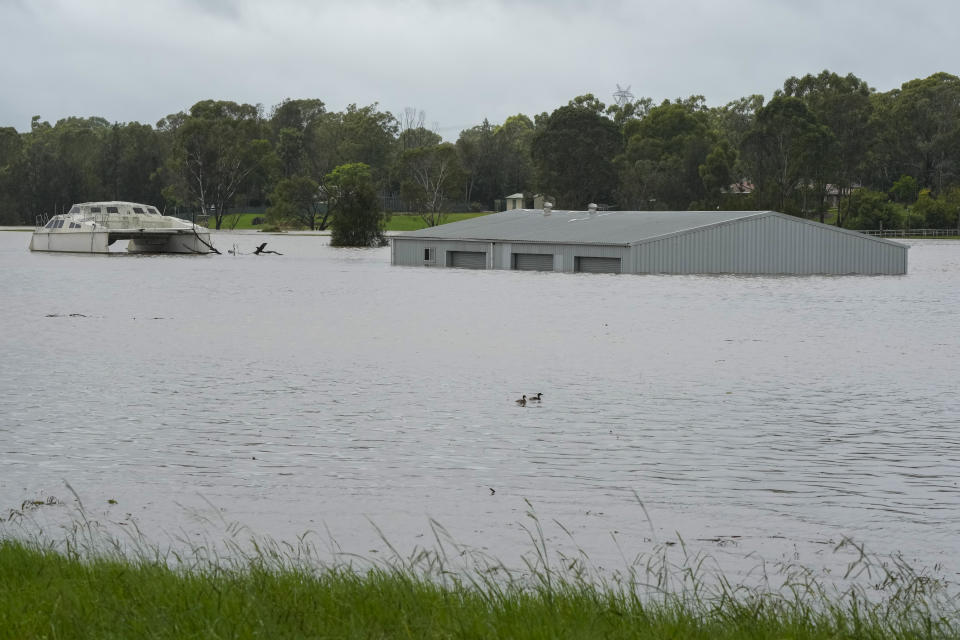 A building is submerged in flood waters near Windsor on the outskirts of Sydney, Australia, Thursday, March 3, 2022.Tens of thousands of people had been ordered to evacuate their homes and many more had been told to prepare to flee as parts of Australia's southeast coast are inundated by the worst flooding in decades. (AP Photo/Rick Rycroft)