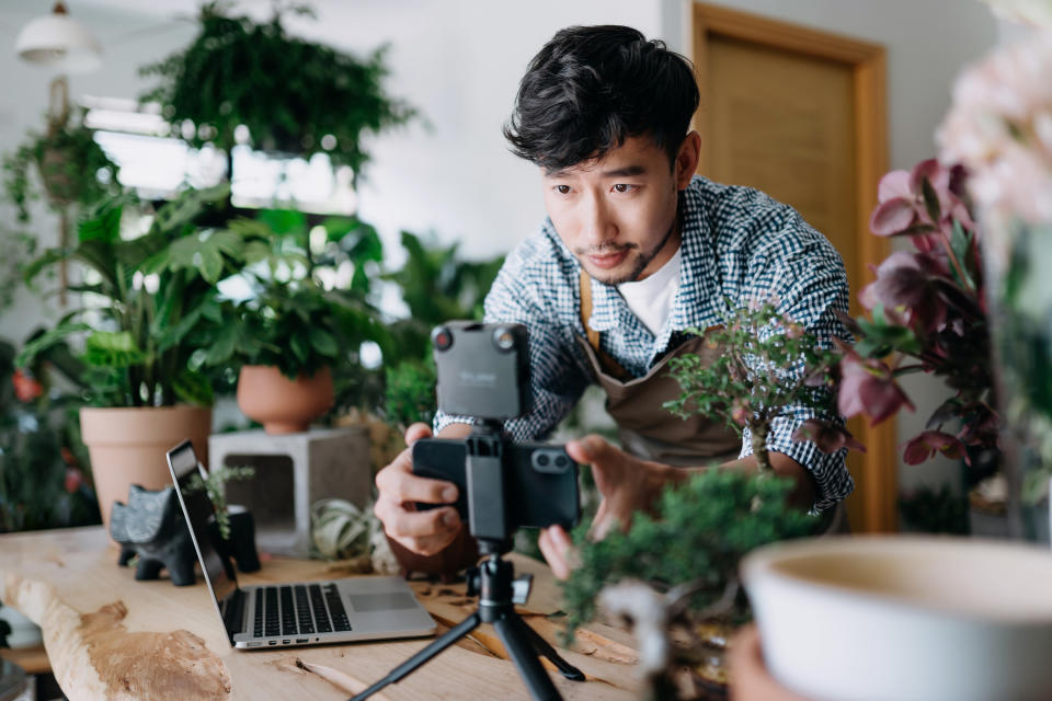 small business owner setting up a camera to make social media content