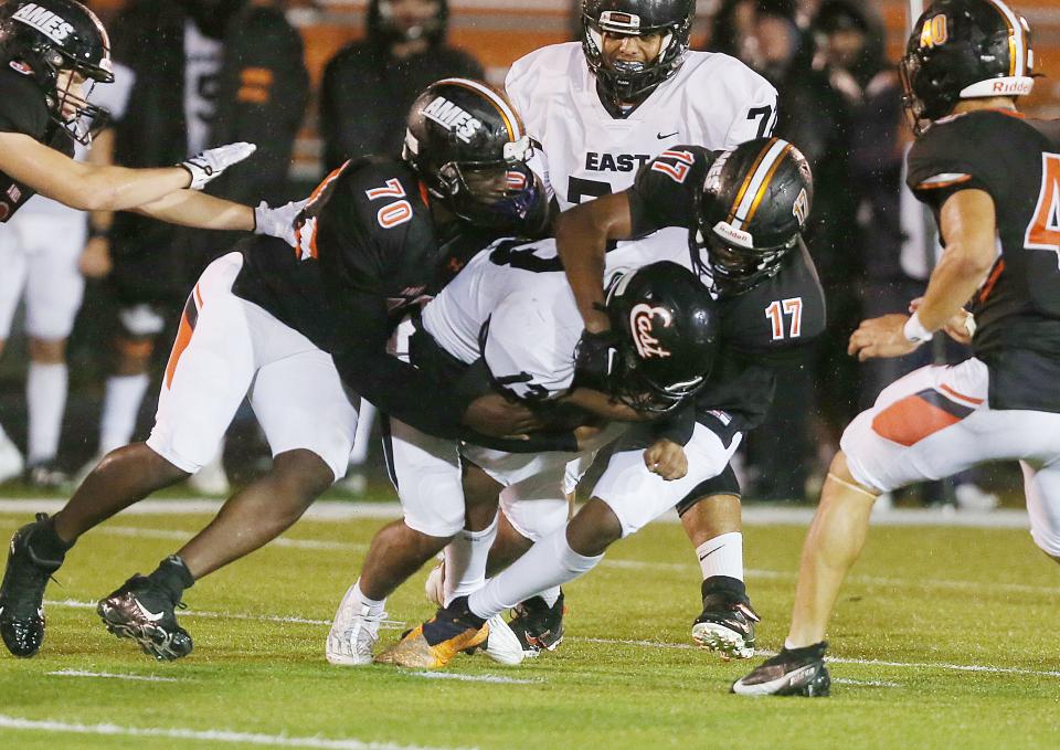 Ames defensive linemen Blaeton Busano (70) and Matt Hall (17) take down Sioux City East running back Dane Milton (3) during the third quarter of the Little Cyclones' 35-28 loss to the Black Raiders on Friday, Oct. 13, 2023, in Ames, Iowa.