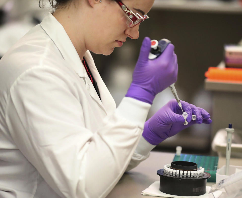 In this March 10, 2020, photo, Heather Peters, a lab technologist, works in the extracting of RNA from test samples in the Mayo virology lab at the Mayo Clinic Superior Drive facility in Rochester, Minn. Vice President Mike Pence has an appointment Tuesday at Minnesota’s Mayo Clinic to learn about a new coronavirus testing “moonshot” that has the famed clinic partnering with the state and its flagship university to quickly boost the state's capacity to 20,000 tests a day. (David Joles/Star Tribune via AP)