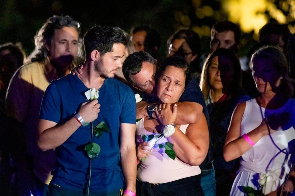 People get emotional during a community beach vigil for those missing and deceased after the partial collapse of Champlain Towers South in Surfside on Monday, June 28, 2021.
