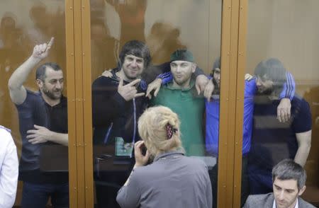 FILE PHOTO: (L-R) Khamzat Bakhayev, Temirlan Eskerkhanov, Shadid Gubashev, Anzor Gubashev and Zaur Dadayev, convicted of involvement in the killing of Russian opposition leader Boris Nemtsov, react inside the defendants' cage during a hearing at the Moscow military district court, Russia July 12, 2017. REUTERS/Tatyana Makeyeva