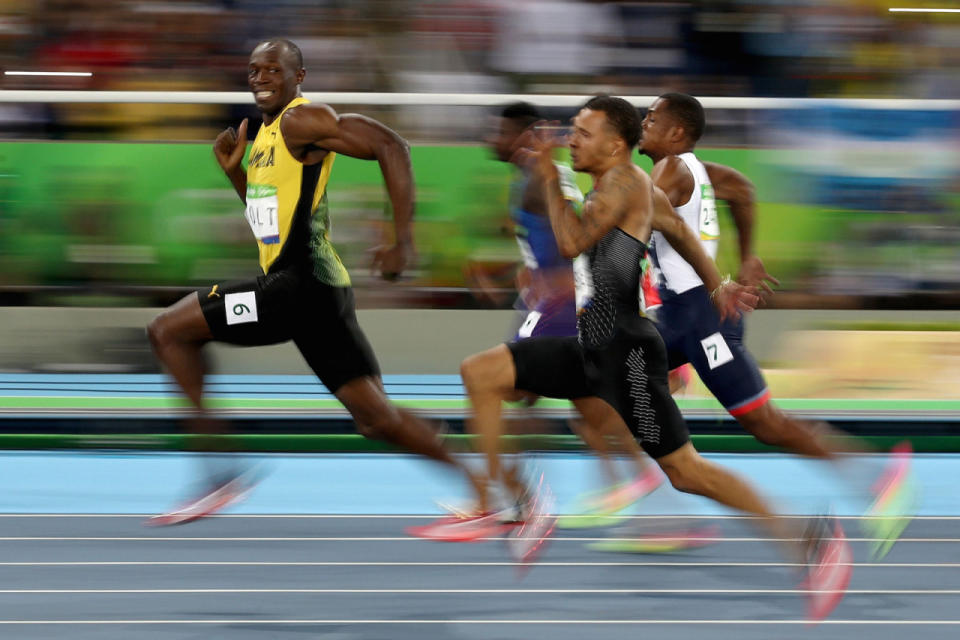 Usain Bolt grins at the competition during the Men’s 100m Semifinals.