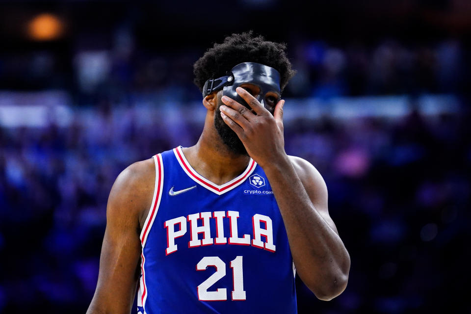 Philadelphia 76ers' Joel Embiid adjusts his mask during the second half of Game 6 of an NBA basketball second-round playoff series against the Miami Heat, Thursday, May 12, 2022, in Philadelphia. (AP Photo/Matt Slocum)