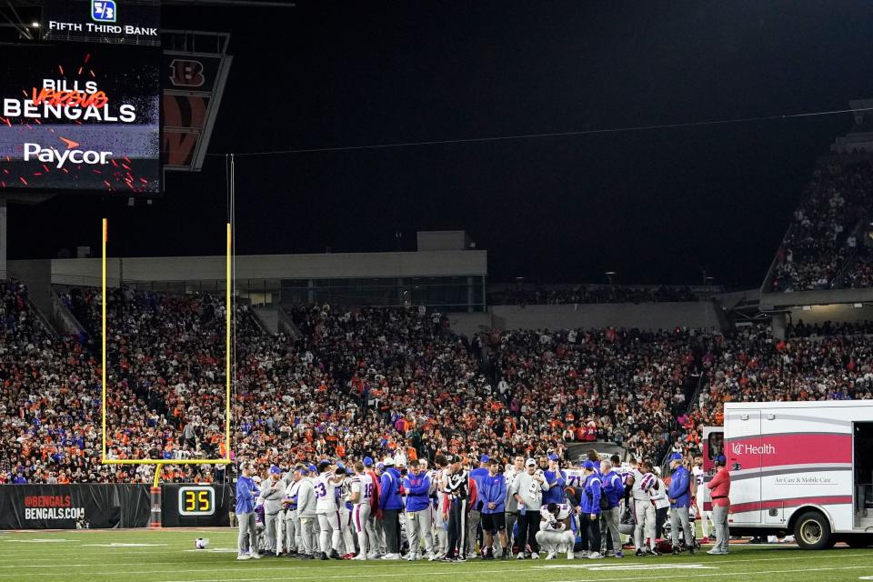 Bills players pray on the field as safety Damar Hamlin receives treatment.