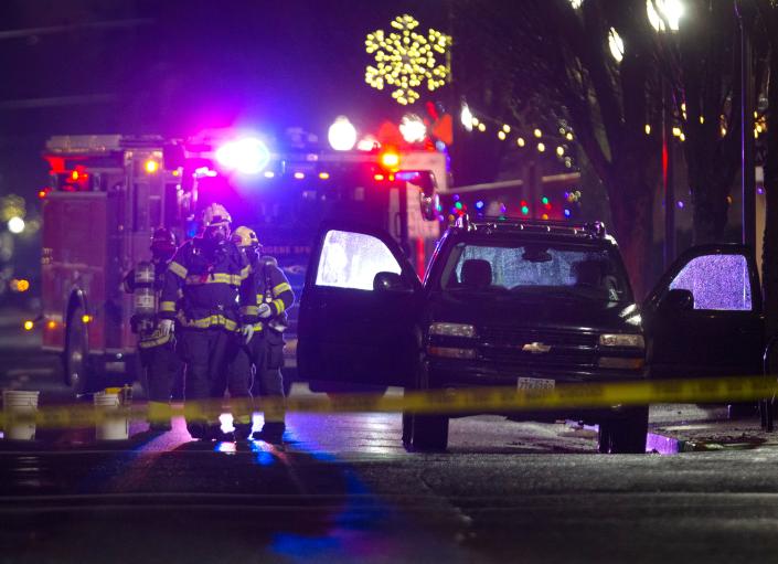 Eugene Springfield firefighters block the street near a vehicle parked in Main Street just east of Pioneer Parkway East in Springfield after a report of hazardous gas in the area on Monday, Dec. 20, 2021.