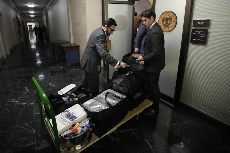 Staff members bring in food before Republicans meet to decide who to nominate to be the new House speaker, on Capitol Hill in Washington, Monday, Oct. 23, 2023. (AP Photo/Alex Brandon)
