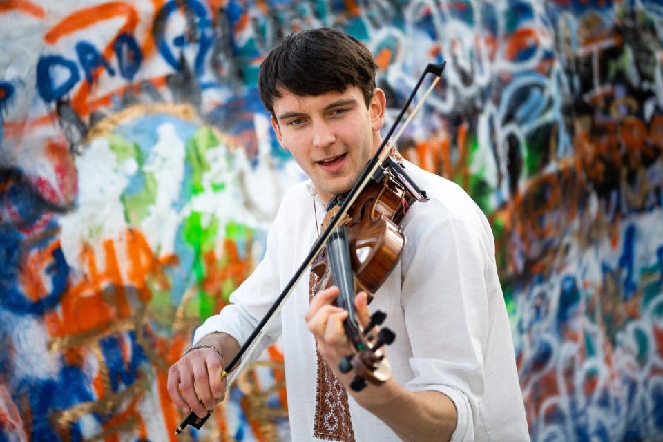 University of Tennessee violin performance student Marki Lukyniuk plays Rocky Top in front of The Rock on campus on Thursday, Dec. 15, 2022. Marki, 22, arrived at UT from Ukraine in September to continue his studies while Ukraine continued to battle a war sparked by RussiaÕs February invasion.