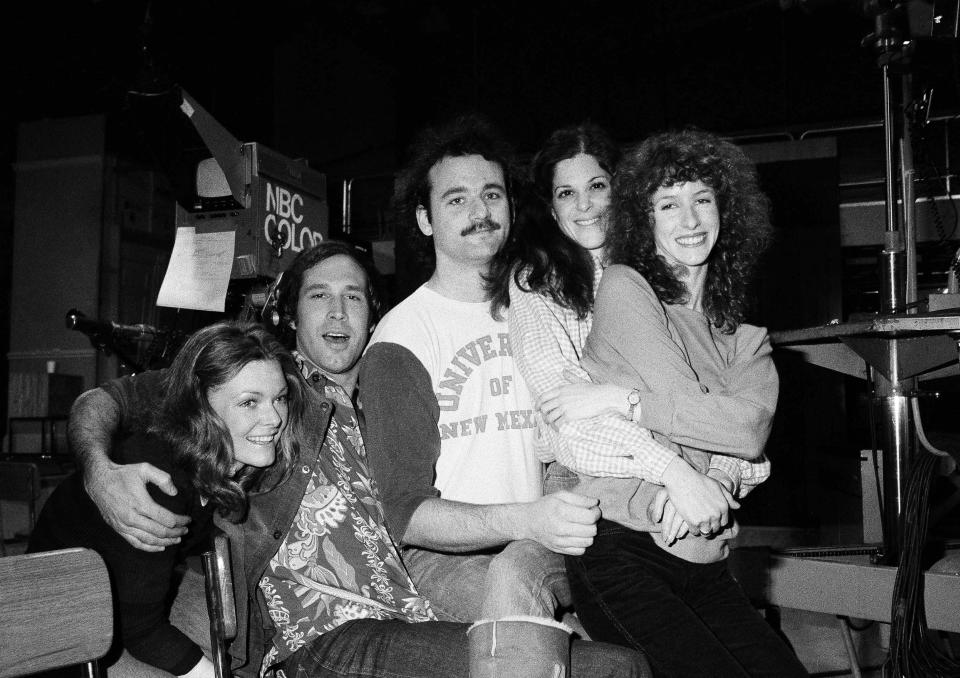 Comedian Chevy Chase, second from left, joins cast of NBC-TV's "Saturday Night Live," Feb. 16, 1978 in New York, where he first got his start with the "Not Ready For Prime Time Players." Others are, from left, Jane Curtin, Bill Murray, Gilda Radner, and Laraine Newman. Chase is doing a guest shot on the program. (AP Photo/Marty Lederhandler)