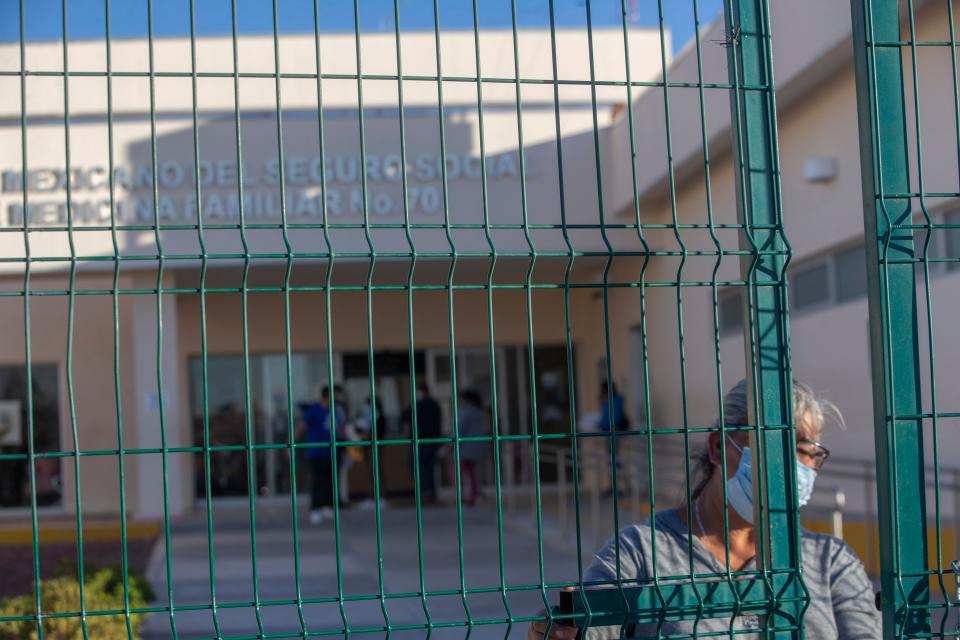 An employee of the Instituto Mexicano del Seguro Social (IMSS) health clinic #70 in the outskirts of Ciudad Juárez keeps guard at the entrance. The health clinic is one of the public health clinics designated to provide health care for COVID-19 infections in the border city.