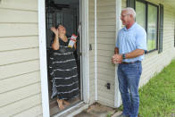 Glenn Cook, a Republican campaigning door-to-door for a seat in the Georgia state House, speaks with Perla Smith, left, in Kingsland, Ga., Tuesday, June 11, 2024. By using artificial intelligence generated content in his campaign, he says the savings – in both time and money – have let him knock on more doors in the district and attend more in-person campaign events. (AP Photo/Gary McCullough)