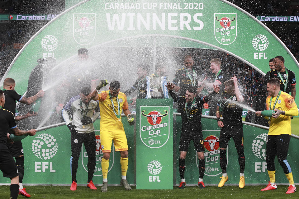 Manchester City players celebrate winning the League Cup soccer match final with a 2-1 score against Aston Villa, at Wembley stadium, in London, England, Sunday, March 1, 2020. (AP Photo/Ian Walton)