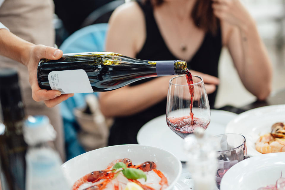 A server pouring wine