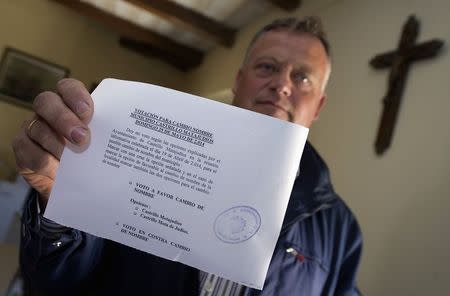 Lorenzo Rodriguez, mayor of the village Castrillo Matajudios (Kill Jews Fort) in northern Spain, holds a ballot for the village's name change May 16, 2014. REUTERS/Ricardo Ordonez