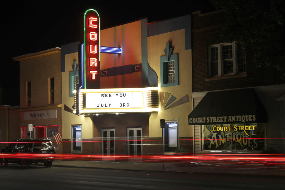 Traffic passes by the Court Street Theatre Monday, June 29, 2020, as the marque signals its reopening date in Saginaw, Mich. The unemployment rate around Saginaw is now 25.6%. (AP Photo/Charles Rex Arbogast)