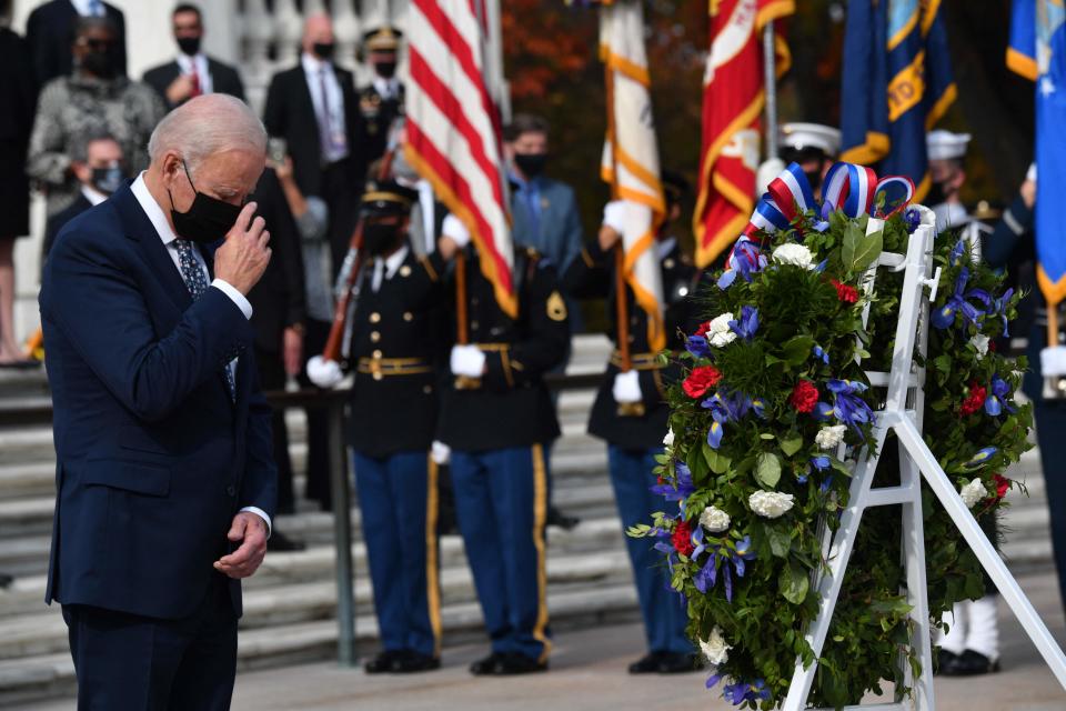 President Joe Biden prays during a wreath-laying ceremony at The Tomb of the Unknown Soldier to commemorate Veterans Day at Arlington National Cemetery in Arlington, Virginia, on Nov. 11, 2021,