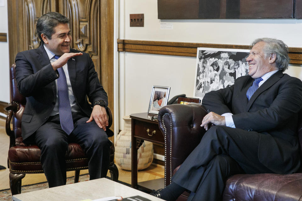 Honduran President Juan Orlando Hernandez, left, meets with Organization of American States (OAS) Secretary General Luis Almagro, Tuesday, Aug. 13, 2019, at the Organization of American States, in Washington. (AP Photo/Jacquelyn Martin)