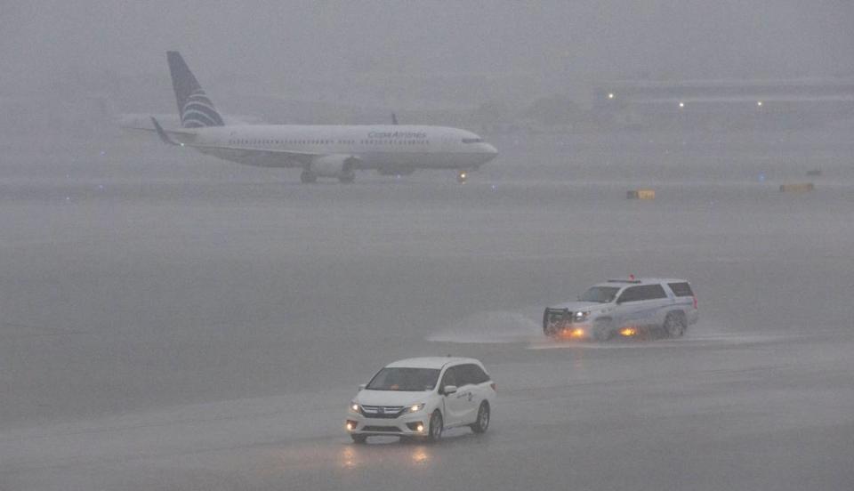 A plane is seen on the runway as heavy rain falls over Fort Lauderdale-Hollywood International Airport on Wednesday, June 12, 2024 in Fort Lauderdale, Florida.  Many flights were canceled or delayed due to bad weather.