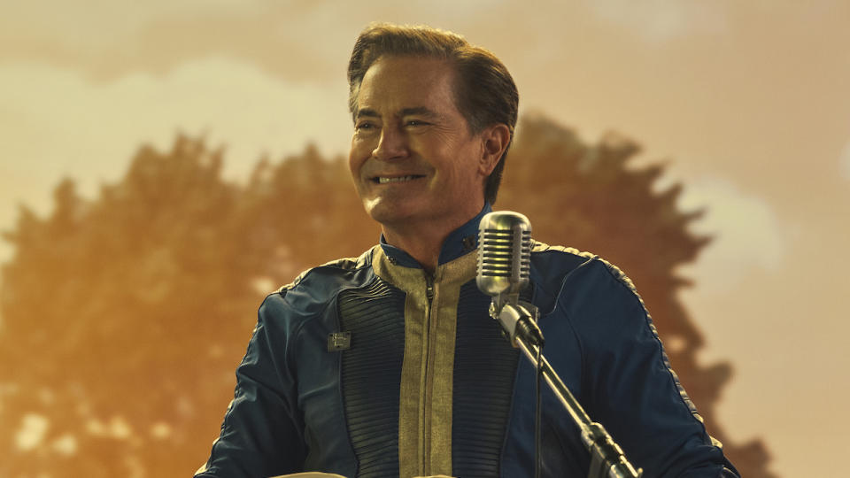 Kyle MacLachlan smiles at the microphone in Fallout.