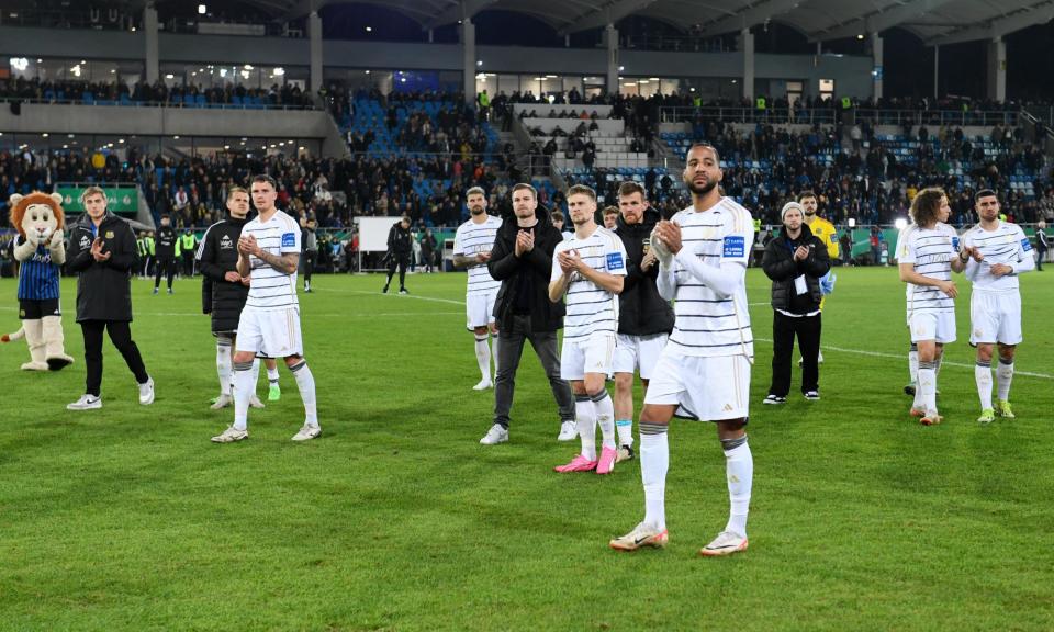 <span>Saarbruecken's players acknowledge fans after their DFB Pokal semi-final defeat to Kaiserslautern.</span><span>Photograph: Jean-Christophe Verhaegen/AFP/Getty Images</span>