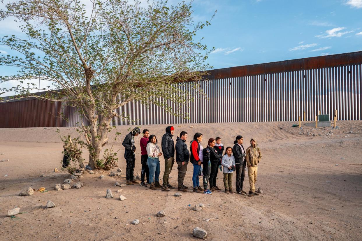 <span>People wait to be processed in El Paso, Texas, after crossing the Rio Grande river on 2 April 2024.</span><span>Photograph: Brandon Bell/Getty Images</span>