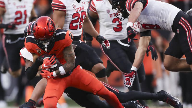 Oregon State wide receiver Anthony Gould (2) is brought down by Utah cornerback Zemaiah Vaughn during the first half of an NCAA college football game Friday, Sept. 29, 2023, in Corvallis, Ore.