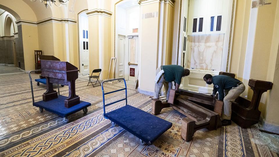 Capitol workers remove damaged furniture on the first floor of the Senate side of the U.S. Capitol on Thursday morning, January 7, 2021, following the riot at the Capitol the day before.