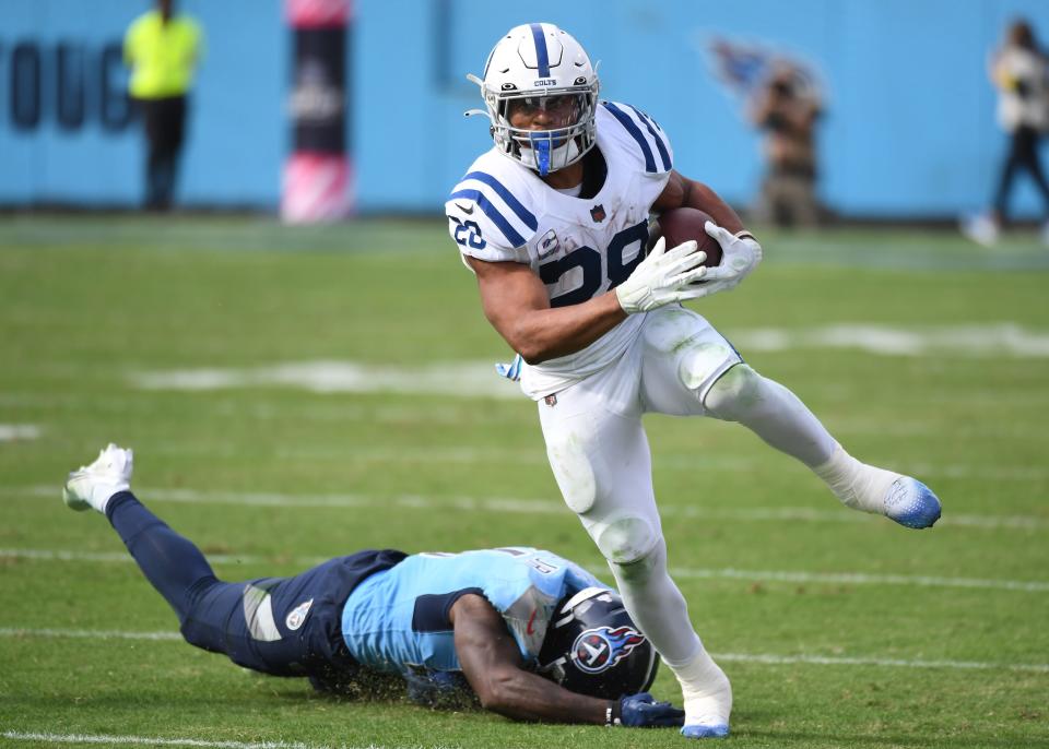 Indianapolis Colts running back Jonathan Taylor (28) gets away from a tackle attempt by Tennessee Titans linebacker David Long Jr. (51) during the second half at Nissan Stadium.