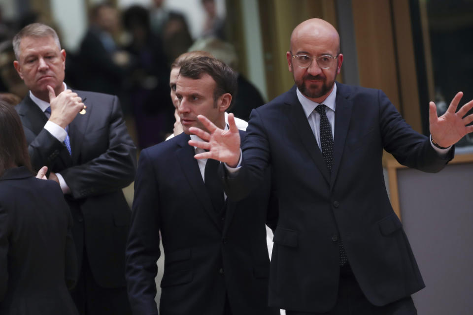 European Council President Charles Michel, right, gestures as he arrives for a round table meeting at an EU summit in Brussels, Thursday, Dec. 12, 2019. European Union leaders gather for their year-end summit and will discuss climate change funding, the departure of the UK from the bloc and their next 7-year budget. (AP Photo/Francisco Seco)