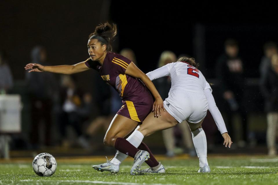 Cooper's Maleah Alexander (12) battles for the ball against Saint Henry's Amanda Schlueter (2) in the second half at Cooper High School Sept. 28, 2022.