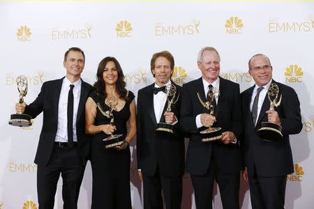 Cast and crew poses with their Outstanding Reality-Competition Program award for the CBS show "The Amazing Race" at the 66th Primetime Emmy Awards in Los Angeles, California August 25, 2014. REUTERS/Mike Blake