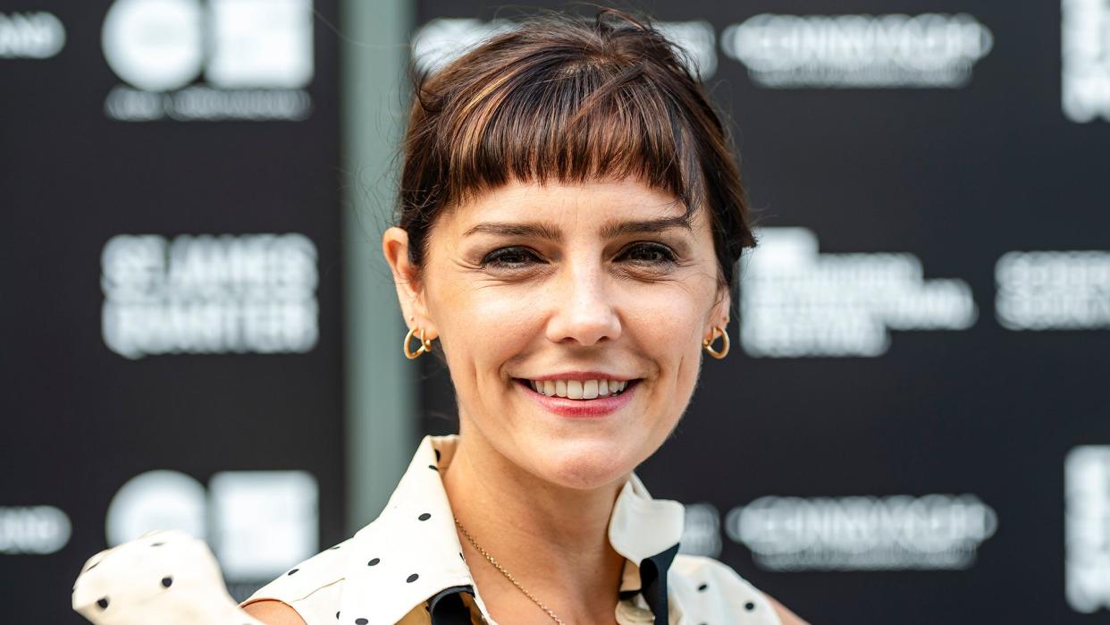 Annabel Scholey smiling in a polka dot dress. 