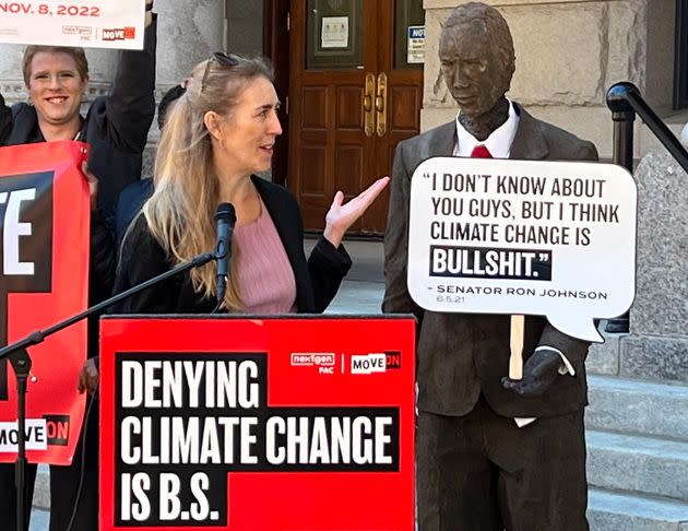 Climate change activists in Wisconsin casually talk with a feces sculpture that looks like Sen. Ron Johnson. (Photo: NextGen PAC)