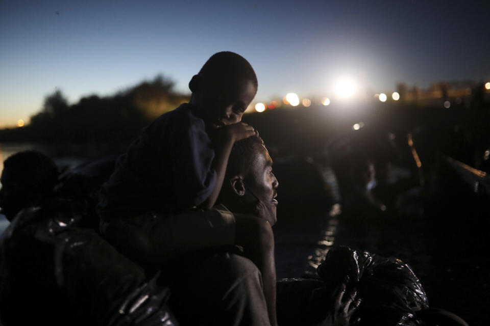 FILE - Migrants, most from Haiti, cross the Rio Grande towards Del Rio, Texas, from Ciudad Acuña, Mexico, Sept. 23, 2021. In September, about 15,000 mostly Haitian refugees were camped under a bridge in the small border town. (AP Photo/Felix Marquez, File)