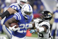 Indianapolis Colts running back Marlon Mack, front left, runs past Jacksonville Jaguars' D.J. Hayden, right, during the first half of an NFL football game, Sunday, Nov. 17, 2019, in Indianapolis. (AP Photo/Michael Conroy)