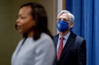 Attorney General Merrick Garland listens as Assistant Attorney General for Civil Rights Kristen Clarke, foreground, speaks at a news conference at the Department of Justice in Washington, Thursday, Aug. 5, 2021, to announce that the Department of Justice is opening an investigation into the city of Phoenix and the Phoenix Police Department. (AP Photo/Andrew Harnik)