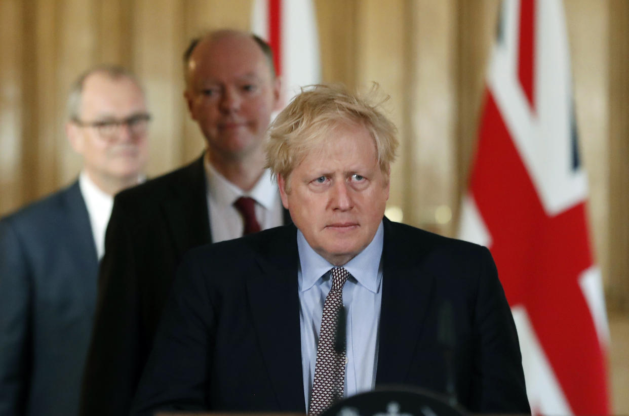 Prime Minister Boris Johnson arrives for a press conference with Chief Medical Officer for England Chris Whitty, (centre), and Chief Scientific Adviser Sir Patrick Vallance, to brief the media on the government's coronavirus action plan, at Downing Street in London.