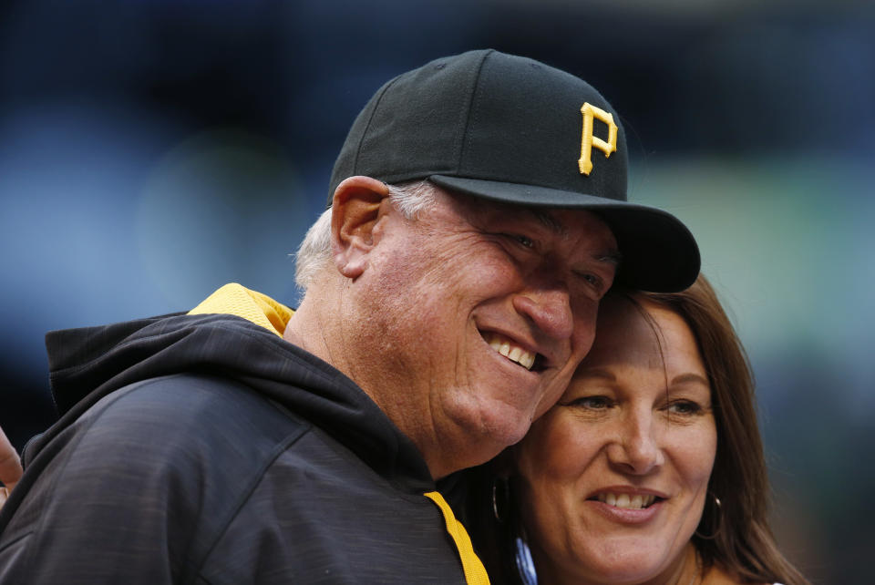 FILE - In this April 25, 2016, file photo, Pittsburgh Pirates manager Clint Hurdle, left, greets a well-wisher before the Pirates faced the Colorado Rockies in a baseball game in Denver. Hurdle began sending his daily notes of inspiration more than 10 years ago, during his days managing the Colorado Rockies. What used to be group text messages have turned into much more -- every morning, his Daily Encouragement emails go out to some 5,000 eager recipients. (AP Photo/David Zalubowski, File)