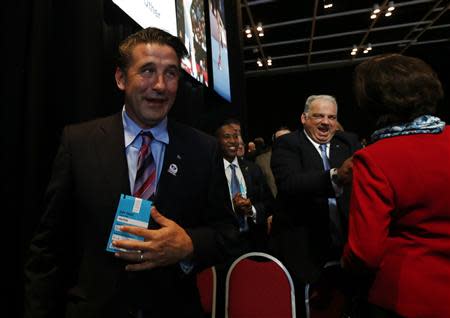 William Baldwin (L), U.S. actor and member of the International Federation of Associated Wrestling Styles (FILA) and FILA President Nenad Lalovic (2nd R) react after the announcement that wrestling is to be included in the Olympic Games in Buenos Aires September 8, 2013. Wrestling won back its spot in the 2020 Tokyo Olympics after beating bids from rivals squash and baseball/softball in an International Olympic Committee vote on Sunday. REUTERS/Marcos Brindicci