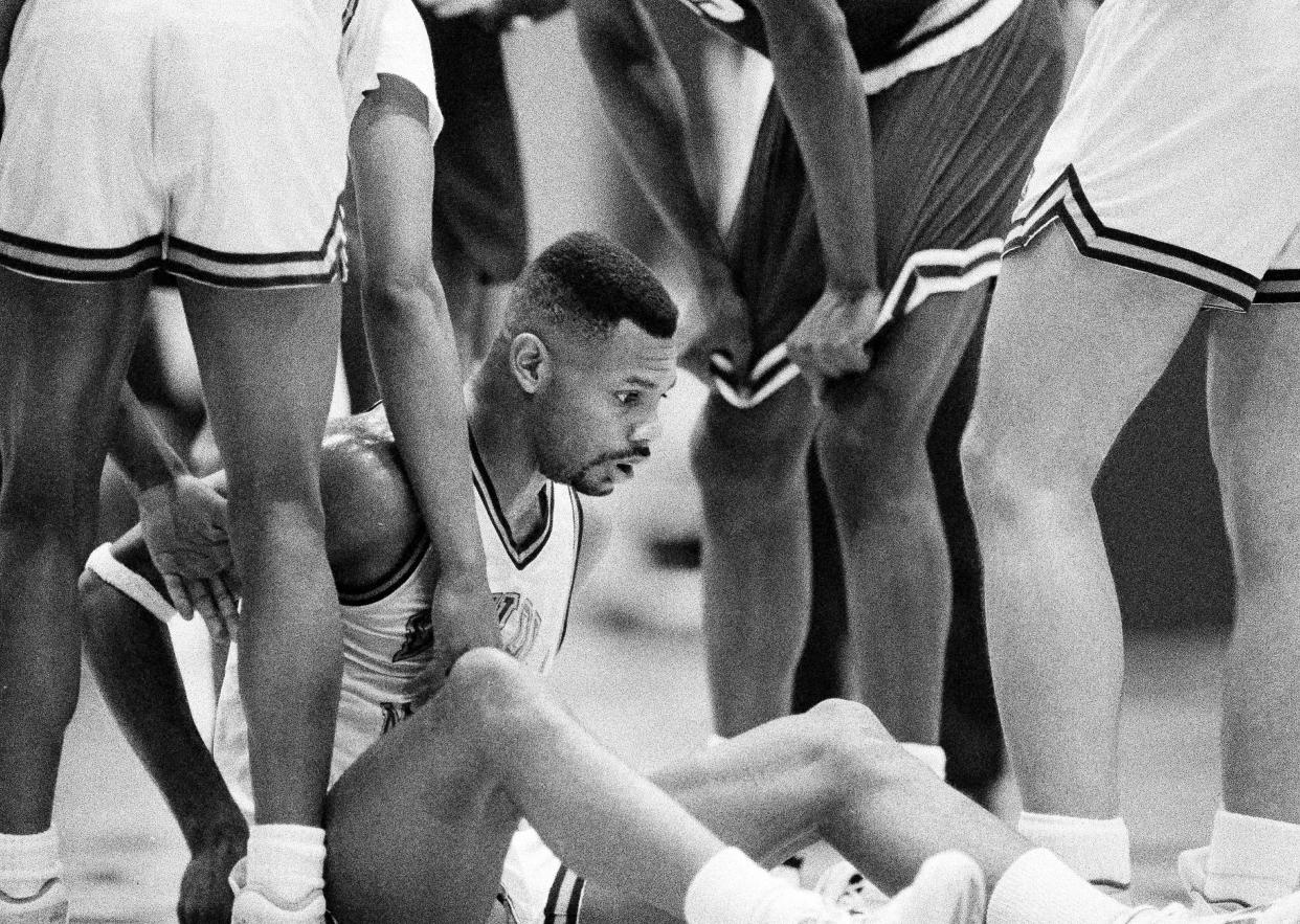 A dazed Hank Gathers, the West Coast Conference's all-time leading scorer and No. 11 on the NCAA's all-time scoring list, sits up after collapsing on he court in Los Angeles during Loyola Marymount's game against Portland in the semi-finals of the West Coast Conference Tournament, March 4, 1990. (AP Photo/Doug Sheridan)