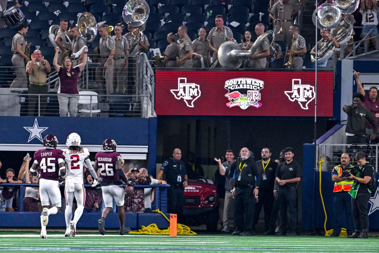 Texas A&M defensive back Demani Richardson scores on an 82-yard gallop after retrieving the ball from teammate Tyreek Chappell, who recovered an Arkansas fumble in the second quarter of Saturday's 23-21 win at AT&T Stadium. The Aggies have won consecutive games after losing to Appalachian State.