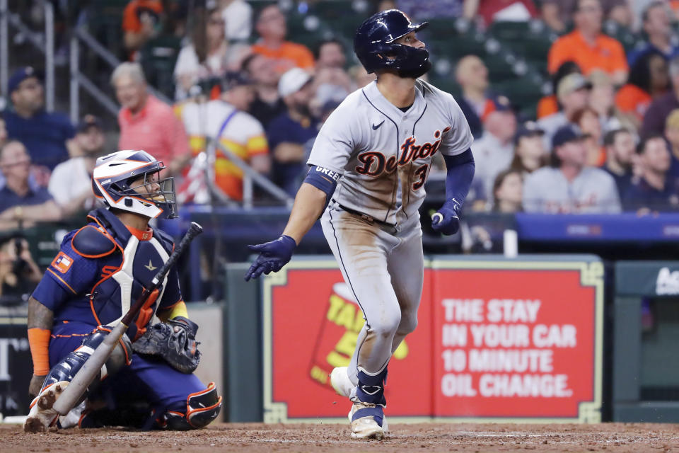 Detroit Tigers center fielder Riley Greene, right, flips his bat as he watches his home run in front of Houston Astros catcher Martin Maldonado, left, during the seventh inning of a baseball game Monday, April 3, 2023, in Houston. (AP Photo/Michael Wyke)