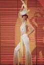 <p>On the <em>Sonny and Cher</em> show in a white hat, cutout halter top, and tiered pants. </p>