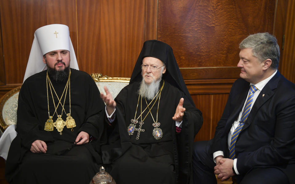 Metropolitan Epiphanius, the head of the independent Ukrainian Orthodox Church, left, Ecumenical Patriarch Bartholomew I, center, and Ukraine's President Petro Poroshenko during a meeting prior to sign "Tomos" decree of autocephaly for Ukrainian church at the Patriarchal Church of St. George in Istanbul, Turkey, Saturday, Jan. 5, 2019. (Mykola Lazarenko, Ukrainian Presidential Press Service/Pool Photo via AP)