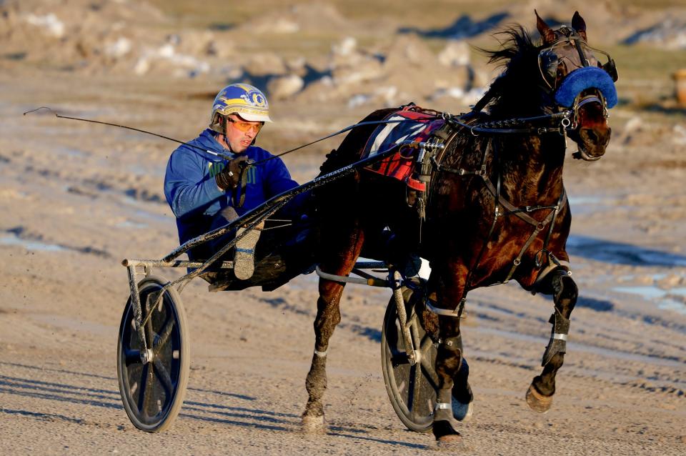 A driver practices around the track with his horse before the last night of harness racing at Northville Downs on Saturday, Feb. 3, 2024.