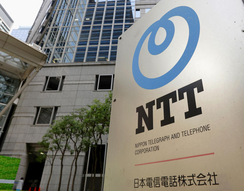 The corporate logo of Japanese telecoms giant Nippon Telegraph & Telephone, or NTT, is seen in front of the building which houses its headquarters, in Tokyo, Tuesday, Sept. 29, 2020. Shares of NTT fell Tuesday on news it is preparing for a takeover of its mobile phone carrier NTT DoCoMo. (Kyodo News via AP)