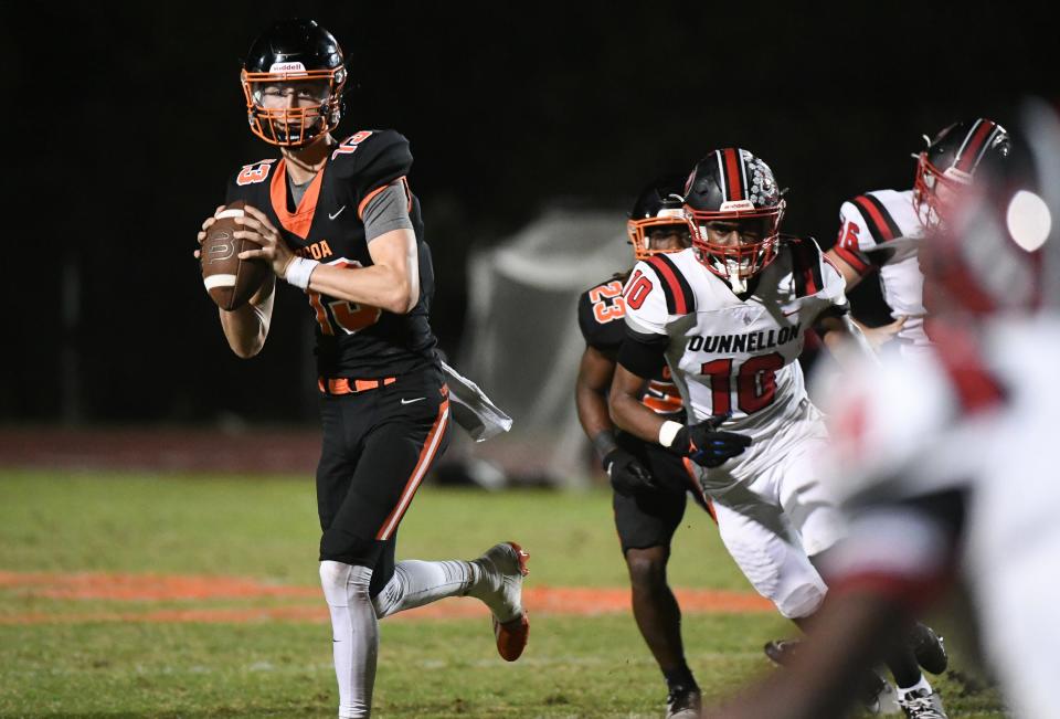 Cocoa QB Brady Hart rolls away from the Dunnellon defense to pass during their game in the FHSAA football playoffs Friday, November 17, 2023. Craig Bailey/FLORIDA TODAY via USA TODAY NETWORK